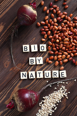 Raw fresh beetroot and red beans bio vegetables on wooden tableの写真素材
