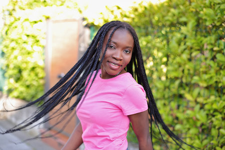 Black young girl with afro dreads hairstyle on the street
