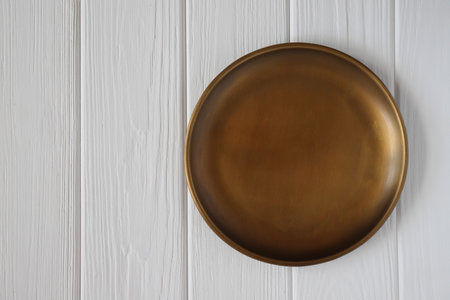 Copper plate mockup on white wooden table, copy spaceの写真素材