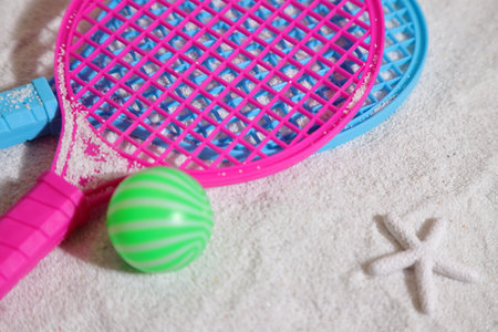 Beach tennis set, rackets and ball on sandの写真素材