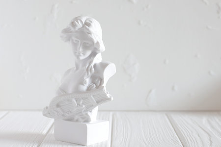 Marble head of young woman, ancient Greek goddess bust isolated on cement background with space for text.の写真素材