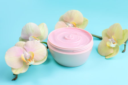 Facial cream cosmetic and orchid flowers, place for textの写真素材