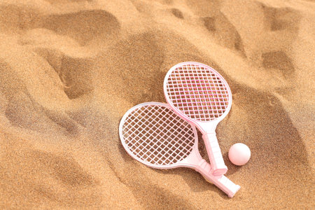 Beach tennis rackets and ball on sand, summer vacation activityの写真素材