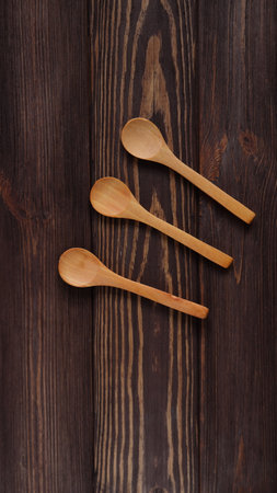 Wooden natural spoons mockup on wood table, spoon templateの写真素材