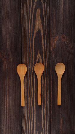 Wooden natural spoons mockup on wood table, spoon templateの写真素材