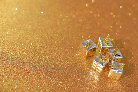 Gold shiny present box for Christmas, New Year gift on glitter backgroundの写真素材