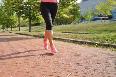 Woman jogger running in urban background, sport outfitの写真素材