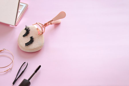 Eye lashes curler tool, beauty tool for eyelashes on pink background
