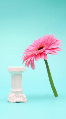 Product display with white roman column in minimalism style with pink gerbera flower on blue background background, mockupの写真素材