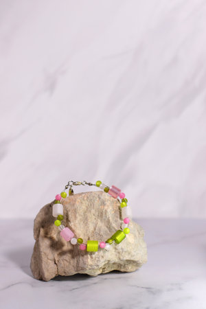 Gem jewelry bracelet, natural beads accessory and pink flowerの写真素材