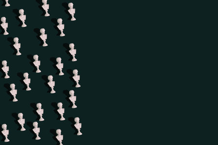 Mini bust of greece statue, concept repetition of bust on green backgroundの写真素材