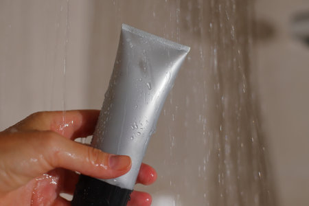 Mockup of skin cleanser in shower under water, shower or shower gel tube mock up