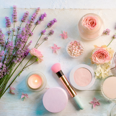 Decorative cosmetic, lipstick, eyeshadow and flowers on wooden table, flat layの素材