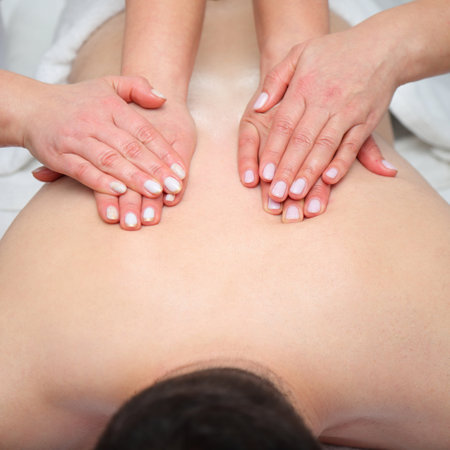 Four hands massage of man back, spa salon wellness, healthcare treatmentの写真素材