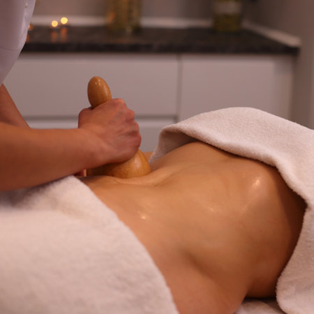 Wooden anticellulite massage in spa salon, body care conceptの写真素材