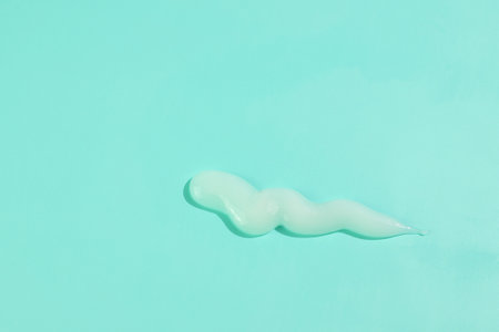 White cream smash on pink background, cosmetic texture smearの写真素材
