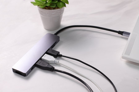 USB hub with cables plugging, electronic device, lifestyle