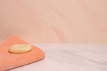 Brown bath towel and natural soap in bathroom, copy spaceの写真素材