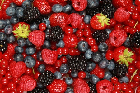 On a table are lying strawberries, bilberries, red currants, raspberries and blackberries On a table are lying strawberries, bilberries, red currants, raspberries and blackberries