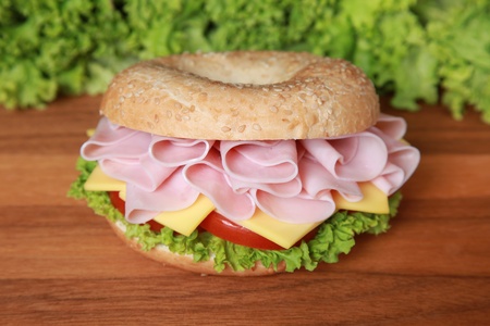 Fresh bagel with ham, cheese and lettuceの写真素材