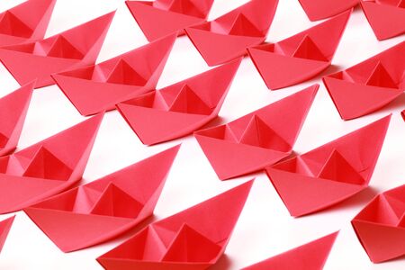 Several red paper boats on white backgroundの写真素材