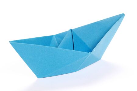 Closeup of a blue paper boat on white backgroundの写真素材