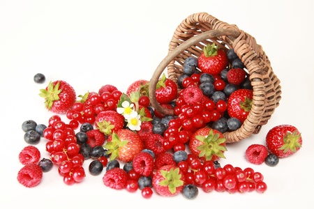 On a table there are strawberries, bilberries, red currants, raspberries and blackberriesの写真素材