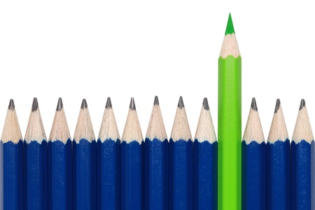 Blue pencils and one green crayon standing out from the crowd. Isolated on white.