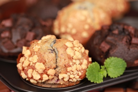 Blueberry and chocolate muffins in a baking sheetの写真素材