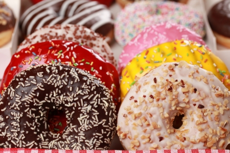 Collection of many colored donuts in a boxの写真素材