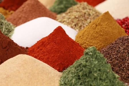 Colorful spices and herbs like pepper, paprika, curry and caraway on a bazaarの写真素材