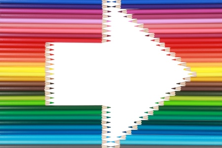 Colored crayons in a row forming an arrowの写真素材
