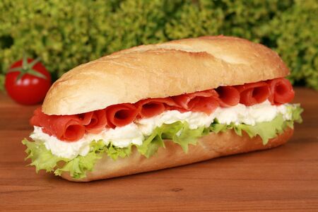 Fresh sandwich with smoked salmon, lettuce and tomatoesの写真素材