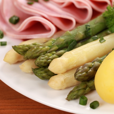 Plate with cooked Asparagus served with ham and potatoesの写真素材