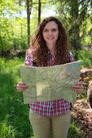 A hiker is reading a map for orientation.の写真素材