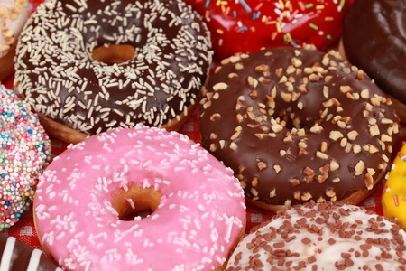 Collection of many colored donuts side by sideの写真素材