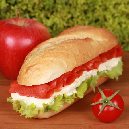 Sandwich with smoked salmon, tomatoes, lettuce and cheeseの写真素材