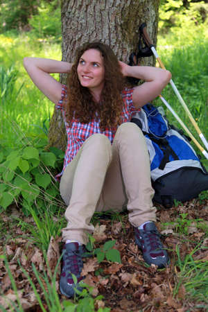 A young woman makes a short break during a Nordic Walking tourの写真素材