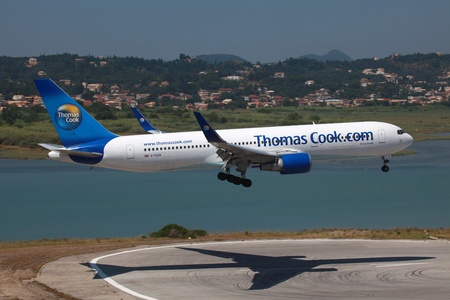 Corfu Island, Greece - July 9, 2012  A Thomas Cook Airlines Boeing 767-300 approaches Corfu Airport in Greece  Thomas Cook Airlines is a British charter airline based in Manchester  It was founded in 1999 and operates with 35 aircraft  In 2011 it carried のeditorial素材