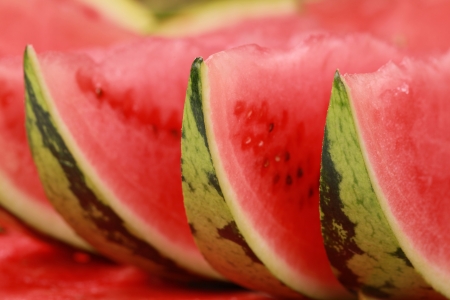 Close-up of arranged fresh slices of red watermelonの写真素材