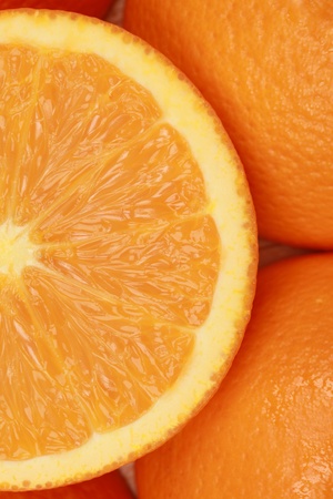 Closeup of a sliced fresh orange, decorated with more orangesの写真素材