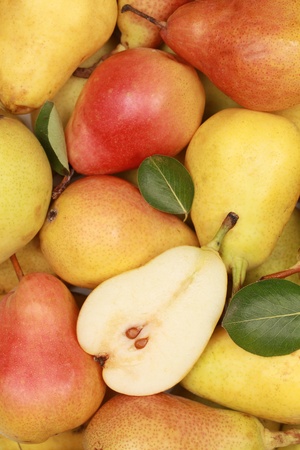 Group of fresh pears with leaves forming a backgroundの写真素材