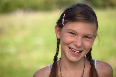 Portrait of a happy smiling young girl with copy spaceの写真素材