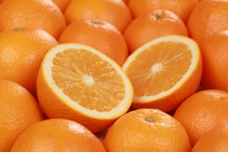 Closeup of sliced fresh oranges, decorated with more oranges Closeup of sliced fresh oranges, decorated with more oranges