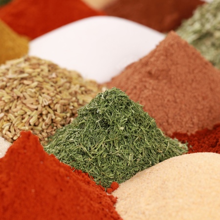 Colorful spices and herbs like paprika, curry and caraway on a bazaar with focus on dill.の写真素材