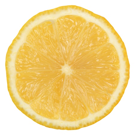 Slice of a ripe lemon isolated on white backgroundの写真素材