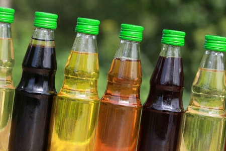 Collection of cooking oil in small bottles. Blurred background.の写真素材