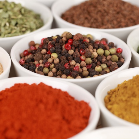 Various spices in bowls. Selective focus on the pepper.の写真素材