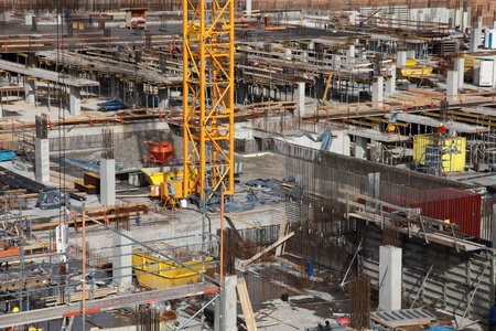 Concrete building under construction with a craneの写真素材