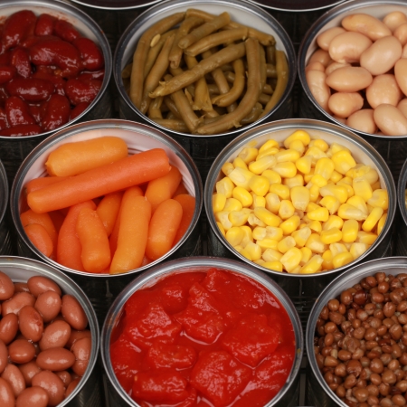 Different kinds of vegetables such as corn and carrots in cansの写真素材